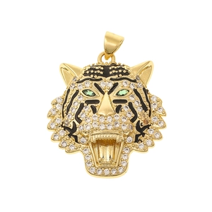 Detailed macro view of gold tiger head pendant with sparkling rhinestones and green gem eyes