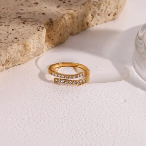 Detail of adjustable gold-plated crossover ring featuring micro-pave sparkling zircons
