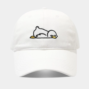 Detail shot of a white cotton baseball cap with cute tired duck embroidery on the front