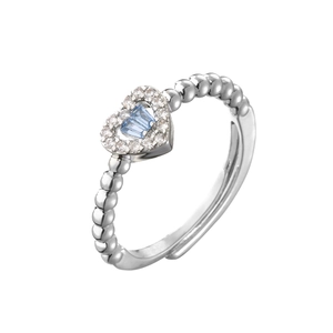 Macro detail of heart-shaped blue zircon ring with silver beaded band and open adjustable size
