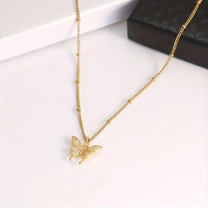 Elegant gold butterfly pendant necklace with zircon crystals on a stylish ball chain