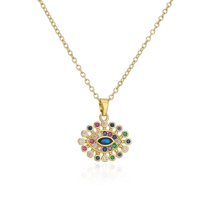 Macro shot of evil eye pendant necklace with colorful zircons on fine gold chain