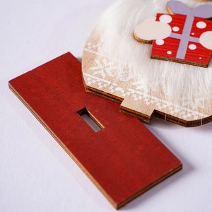 Macro detail of wooden Christmas gnome with faux fur and red painted reindeer antlers