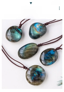 Macro detail of natural labradorite stone pendants with vibrant blue iridescent flashes