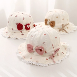 Detail of sweet baby bucket hats featuring lace edges and various ribbon bow accents