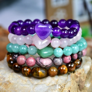 Handmade natural stone beaded bracelets with heart charms in multiple vibrant colors