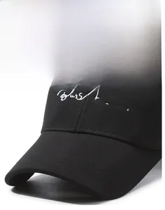 Detailed close-up of a black baseball cap with white embroidered text and curved brim
