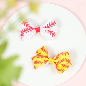 Close-up of baseball pattern hair bows in red and yellow ribbon with white round plate