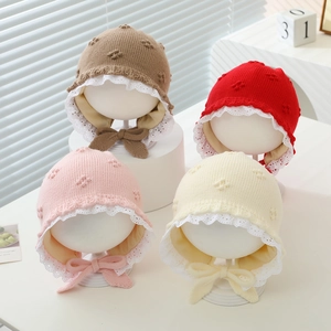 Knit baby bonnet with lace trim and bow ties in multiple colors for winter warmth