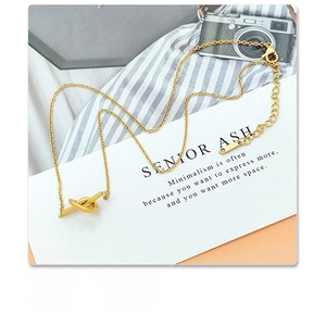 Detail of 18k gold plated surgical titanium steel necklace with a unique knot pendant