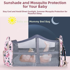 Detail of portable pink floral diaper bag unfolding into a crib with grey mesh net
