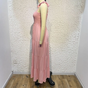 Side view of pink tiered floral maxi dress featuring adjustable tie shoulder straps