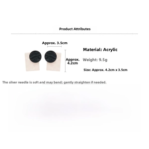 Detail view of geometric acrylic drop earrings with black circle and pink rectangle specs