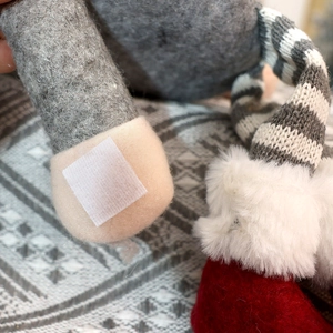 Detail of Christmas gnome curtain tieback with velcro fastener and plush fabric texture