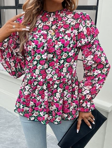 Detailed close-up of the floral pattern and ruffled high-neck collar on this long sleeve blouse