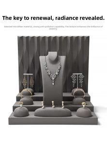 Gray microfiber jewelry display set with necklace bust, earring stands, and ring holders