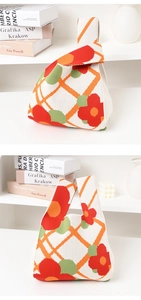 Detail of floral and geometric knit tote bag with soft texture and vibrant patterns
