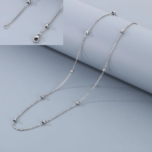 Detail view of silver beaded stainless steel chain with lobster clasp and round spheres