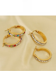 Close-up of gold 18K hoop earrings with multicolor and white crystal rhinestones