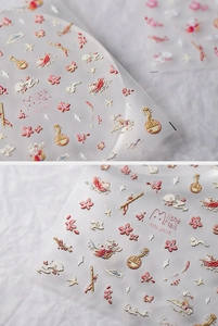 Detail of 3D embossed nail stickers featuring cherry blossoms and traditional motifs