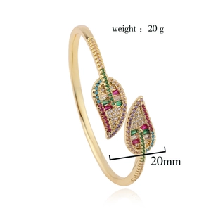 Detail of gold leaf bangle with colorful zircon pave stones and size measurement
