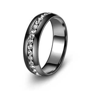 Detail of a polished black stainless steel ring featuring channel-set sparkling crystals