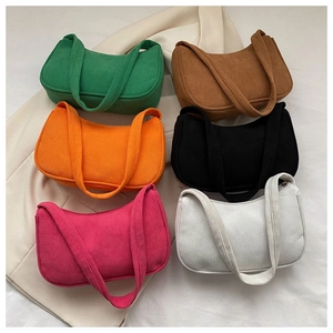 Flat lay of colorful corduroy baguette bags on a beige blazer showing fabric texture