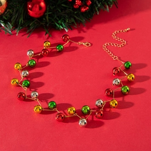 Colorful Christmas bead necklace with festive red, green, and gold spheres on red background