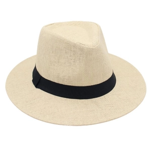 Detail of breathable beige straw fedora featuring a classic black ribbon band decoration