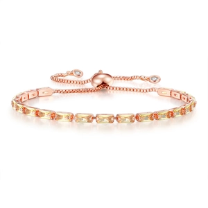 Macro shot of rose gold tennis bracelet featuring yellow rectangular zircon gemstones