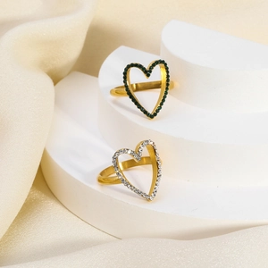 Detailed close-up of 18K gold-plated heart-shaped open rings with green and white zircon stones