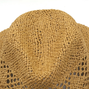 Macro shot of breathable hollow-out weave and raffia texture on a wide brim sun hat