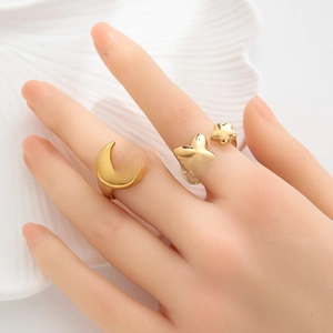 Detail of 18k gold plated stainless steel rings featuring moon and butterfly charms