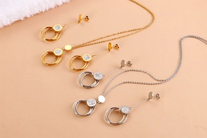 Detail view of gold and silver hollow circular necklaces and earrings set in stainless steel