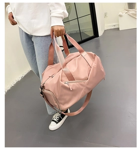 Pink nylon fitness bag with dual handles, detachable strap and side shoe compartment