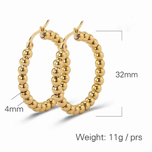 Detail view of 14K gold-plated C-shaped earrings with 4mm beads and 32mm diameter
