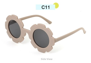 Side view of beige sunflower-shaped sunglasses for kids with round dark lenses