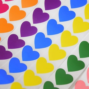Colorful heart shaped stickers in pink orange purple blue yellow and green roll