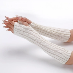 Close-up of white cable knit arm warmers showing soft wool texture and twist pattern