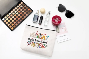 Flat lay of teacher's gift makeup bag with school stationery prints and cosmetics