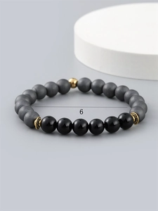Men's beaded bracelet with 6mm matte gray and polished black stones and gold spacers