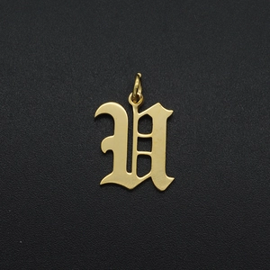 Macro view of a gold-plated stainless steel gothic letter H pendant with hanging ring