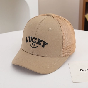 Detailed close-up of breathable mesh back and Lucky embroidery on beige kids cap