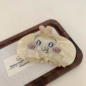 Cute cream-colored acetate hair claw clip featuring a minimalist cartoon rabbit design