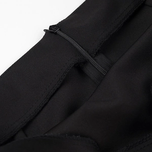 Detailed close-up of the invisible zipper and stitching on a black knit skirt