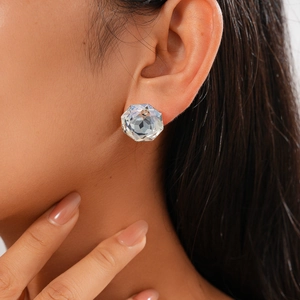 Minimalist geometric round faceted crystal stud earring on model showing clear light refraction