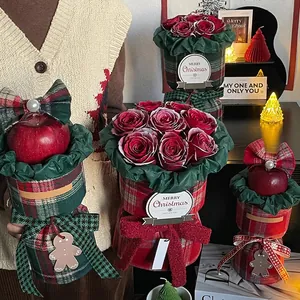 Christmas gift box with red roses, apples and classic British red plaid fabric wrapping
