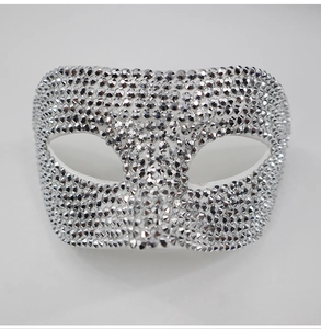 Macro detail of silver masquerade mask featuring sparkling crystal rhinestones inlay