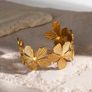 Minimalist 18k gold plated stainless steel cuff bracelet featuring multi-flower designs