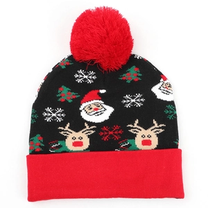 Detail of Christmas knit hat with reindeer patterns and a large red pompom topper
